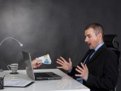 Businessman earning money on network.  He is receiving euro cash over internet.