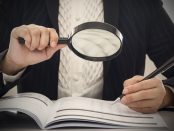 Corruption audit concept. Inspector using magnifying glass for inspect budget corruption.